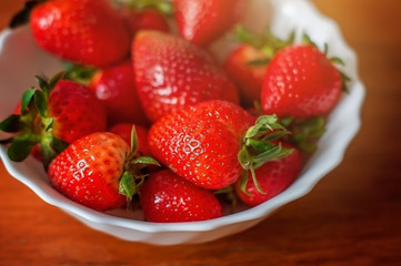 Fresh red strawberry on the plate.