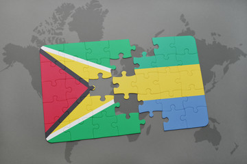 puzzle with the national flag of guyana and gabon on a world map