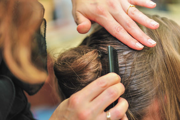 Fototapeta premium Hairdresser styling hair at the salon