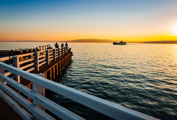 Ferry arrives at pier in Madeline Island at sunset