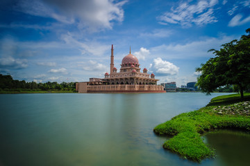 Putrajaya Mosque and its reflection on a calm lake.