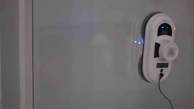 Robot vacuum cleaner working. Vacuum cleaner robot cleaning window. Robotic vacuum cleaner presentation. Smart robot hoover
