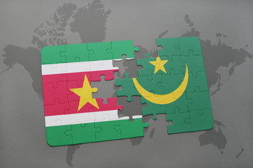 puzzle with the national flag of suriname and mauritania on a world map