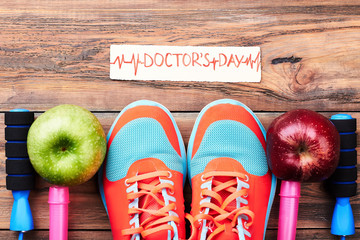 Apples, sport shoes and card. Medical national holiday.