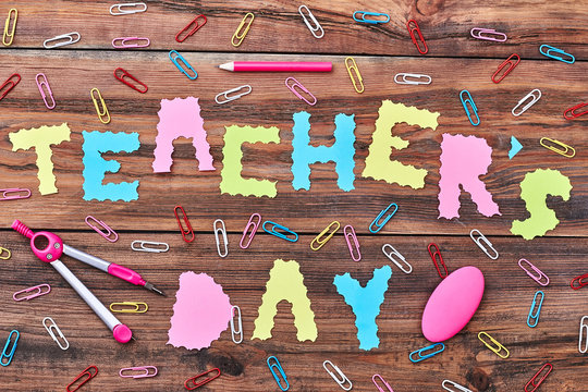 Paper clips, pencil and eraser. Greeting with Teacher's Day.