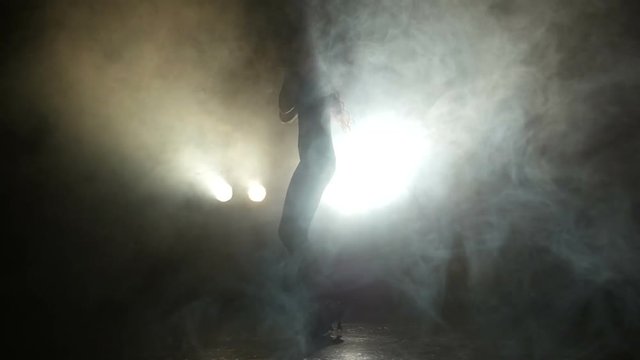 Girl dancing in the studio in the smoke