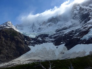 Massive hanging glacier in Valle Frances, constantly being loaded by high winds and snow drift of the towering peaks above. Torres del Paine National Park, Patagonia
