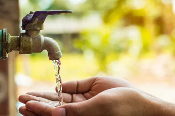 Foto op Plexiglas hand open for drinking tap water © saknakorn
