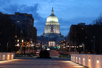 Wisconsin State Capitol building, National Historic Landmark. Madison, Wisconsin, USA. Night scene with official buildings and street holiday decorative illumination.