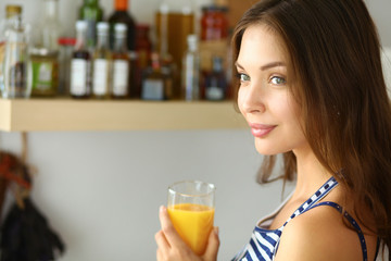 Portrait of a pretty woman holding glass with tasty juice