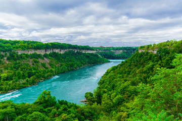 Obraz na płótnie Canvas Beautiful amazing gorgeous view of Niagara Falls river with torrent of water abruptly changes direction and creates one of the worlds most mesmerizing natural phenomena, the Niagara Whirlpool 