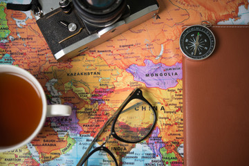 Time to go travel concept : Close up Accessories of traveling people with world map.