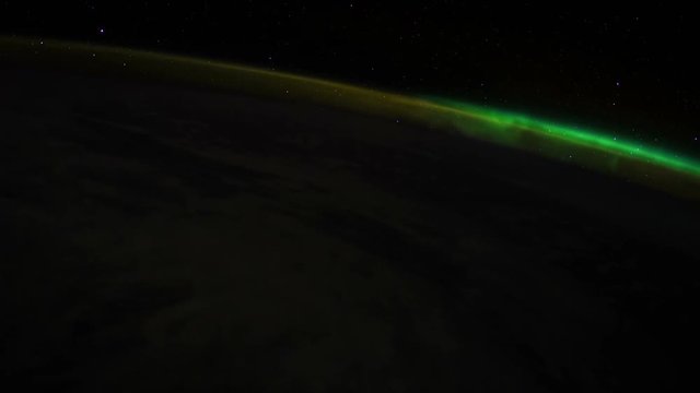 ISS (International Space Station) orbiting earth in 4k film resolution. Brilliant aurora (northern lights) can be seen below. Created with permission by NASA.  Public Domain images from Nasa that have