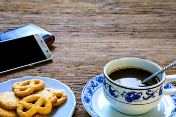 coffee cup and candy on old wood table