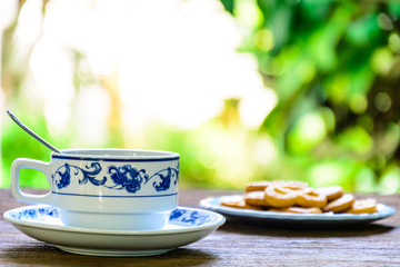 coffee cup and candy on old wood table