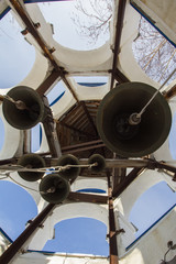 Bell tower inside in christian orthodox monastery at sunny winter day, vertical