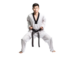 Portrait of a professional asian man taekwondo fighter with black belt on grey background