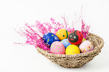 easter eggs in weave basket with pink flower.