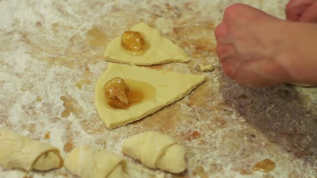 Woman working with dough. making homemade croissants