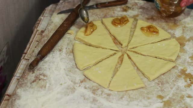 Woman working with dough. making homemade croissants