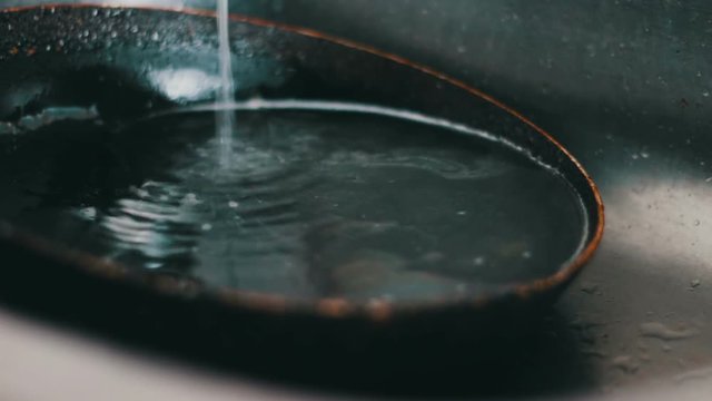 Dirty pan lies in the kitchen sink