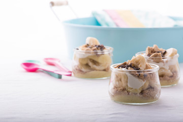 Fototapeta na wymiar Banana vanilla trifle in a mini glass jar 