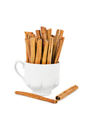 Cinnamon sticks in white cup.