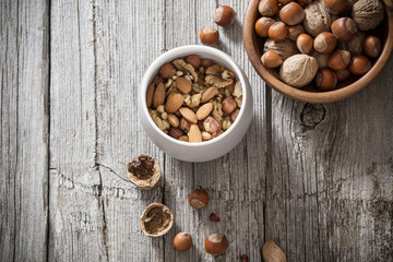 Mixed nuts on old wooden background