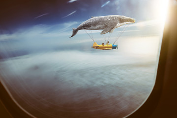 Whale floats in the air above the clouds carrying children in a yellow airplane,seen through window...