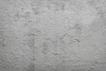 old cracked plaster on the cement wall. grunge textured background