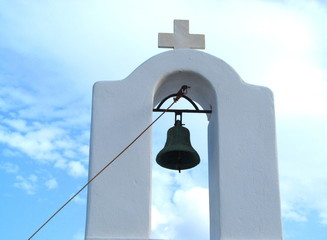 Greek Bell Tower with Cross against Sky and Clouds