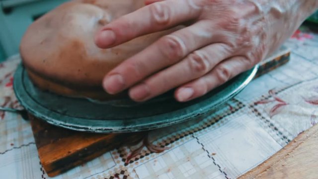 Woman with knife cuts the cake