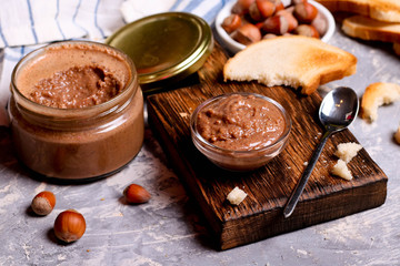 Chocolate paste spread with hazelnuts and bread for breakfast