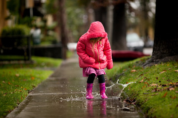 A young girl is playing in the much needed California rain.