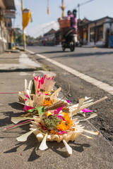 Traditional offerings to gods in Bali with flowers, food and aroma sticks