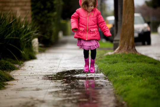 A young girl is playing in the much needed California rain.