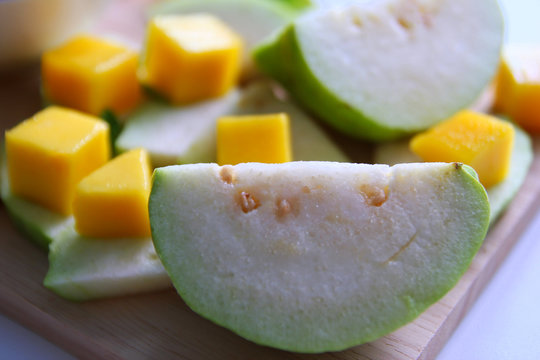 Fresh fruits – guava and mango on the white background.