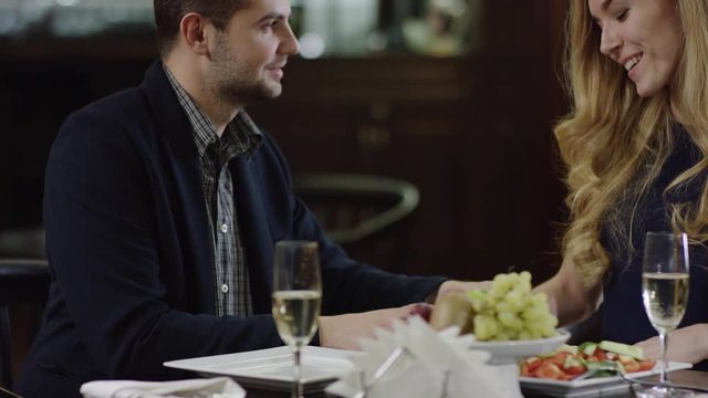 smiling cute lady getting a present to valentines day and kiss man