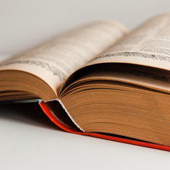 Knowledge concept: big old book with mahy pages open in the middle