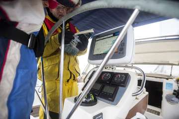 Men With Map Having Discussion On Sail Boat