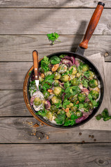 Roasted sprouts in the greek yogurt in frying pan