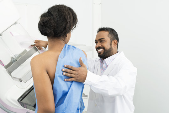 Doctor Assisting Female Patient Undergoing Mammogram X-ray Test
