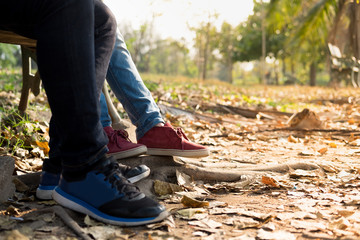 close up person wearing  shoes with blue jean