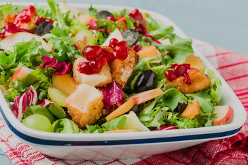 French salad with baked camembert, cranberries and fresh fruit.
