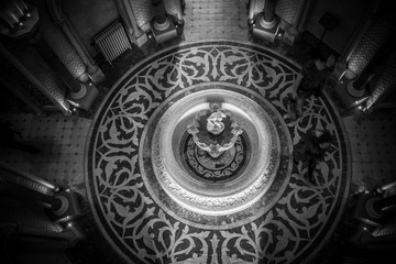Top view from palace hall with a fountain in the center with the reflex of the sun light. 