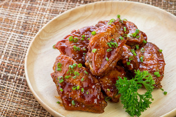 Buffalo Chicken Wings with barbecue sauce,drumsticks and vegetables close up on wooden tray shot thai food