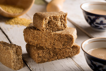 Eastern sweets. Asian delights - kazakh jent on the white wooden table. Tea with milk