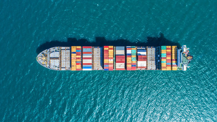 container ship in import export and business logistic.By crane ,Trade Port , Shipping.cargo to harbor.Aerial view.Water transport.International.Shell Marine.Top view.
