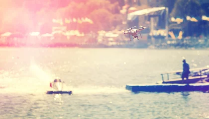 Fotobehang drone en motorboot. professionele foto- en videoreportage. Instagram-filter. creatief beeld. drone over het water. retro stijl. instagram toning-effect © jenyateua