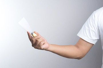 Hand holding putty trowel